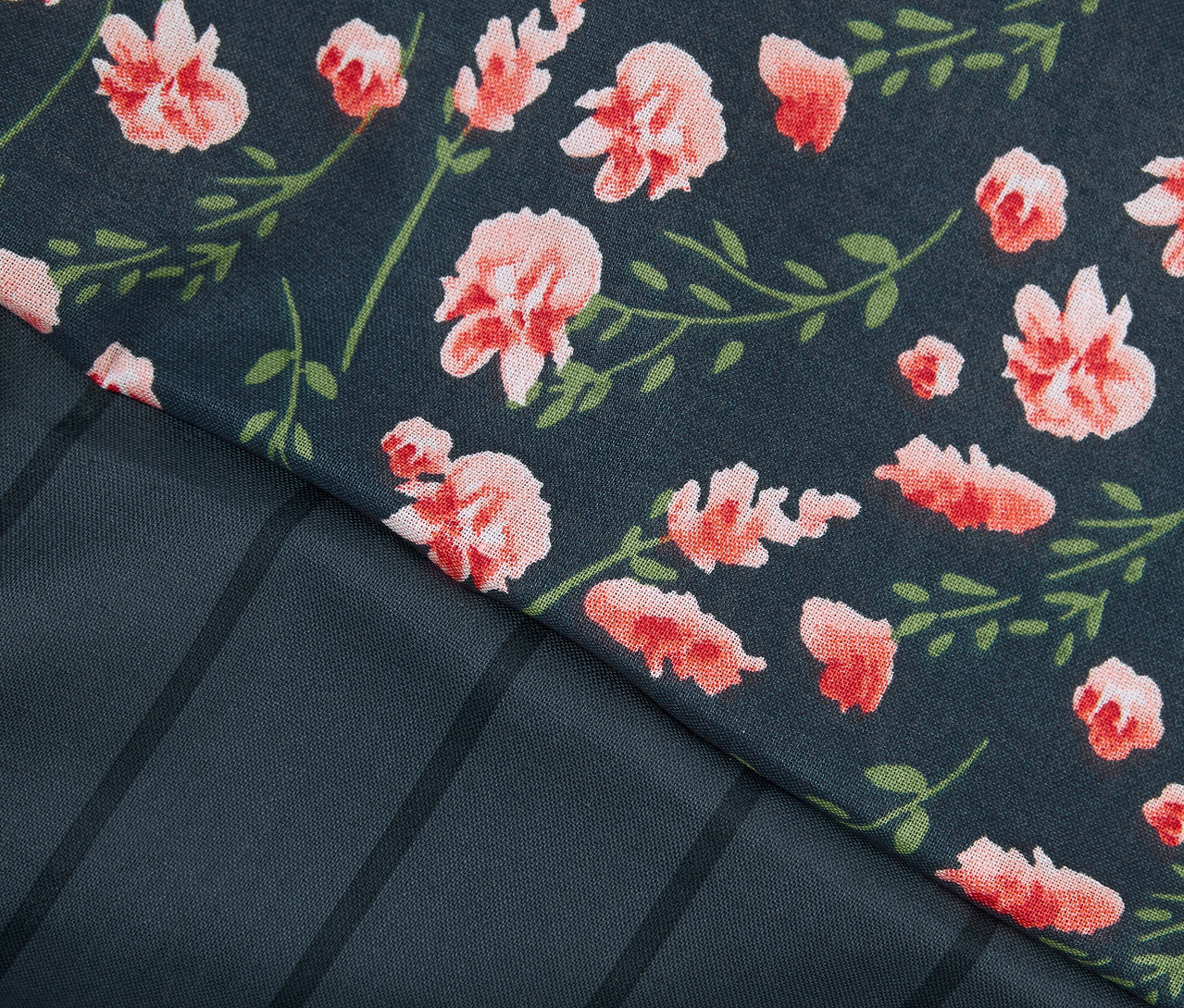 Részlet egy normál méretű, virágos és csíkos mintázatú renforcé ágyneműből.