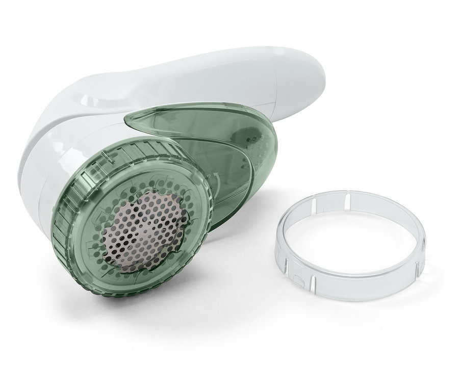 Egy fehér szöszeltávolító átlátszó zöld heggyel és egy átlátszó műanyag gyűrűvel, fehér háttérrel.