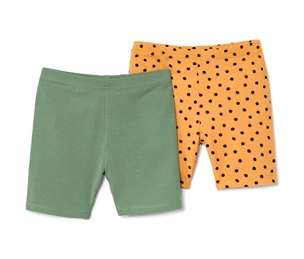 Két gyermek kerékpáros leggings: egy zöld, egy narancssárga fekete pöttyökkel.