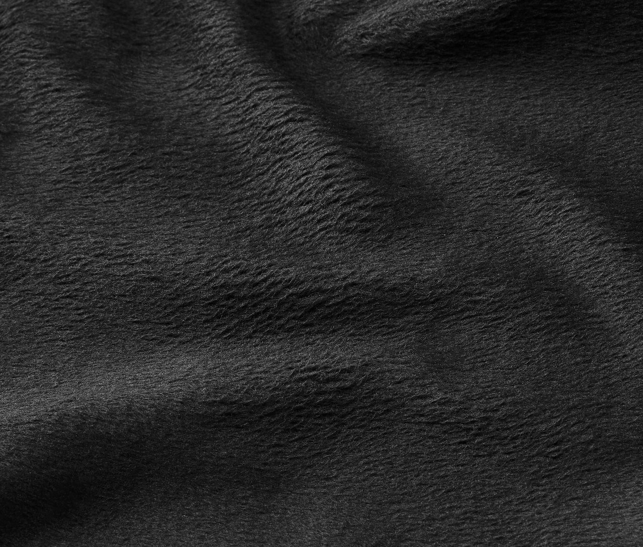 Egy fekete szövet textúrájának közeli felvétele.