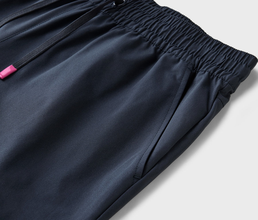 Egy sötétkék, gumis derekú és húzózsinóros nadrág részletfotója