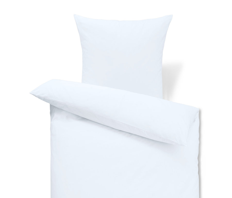 Fehér ágynemű párnával és takaróval.