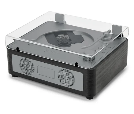Egy CD/Bluetooth® hangszóró átlátszó fedéllel egy fehér felületen áll.