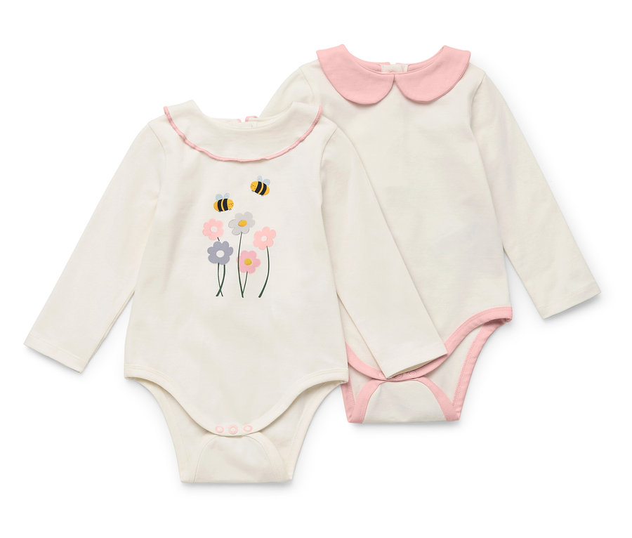 Két fehér, hosszú ujjú babaruha; az egyik virág- és méhmintával, a másik rózsaszín gallérral.