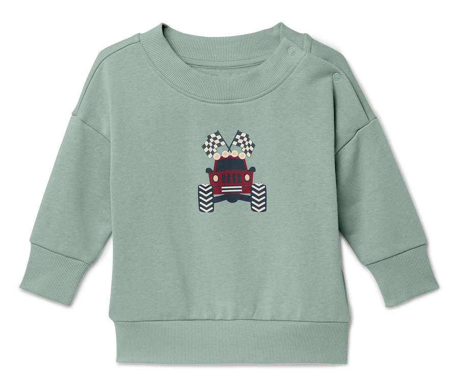 Zöld pulóver piros dzsip és kockás zászlók nyomtatásával.