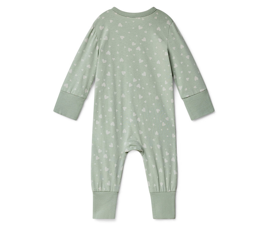 Egy világoszöld, hosszú ujjú, fehér szívmintás babaruha fekszik egy fehér háttéren.