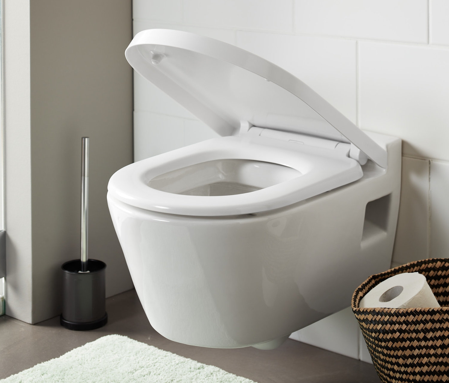 Nyitott prémium, könnyen lehajtható WC-ülőke egy fehér fürdőszobában.