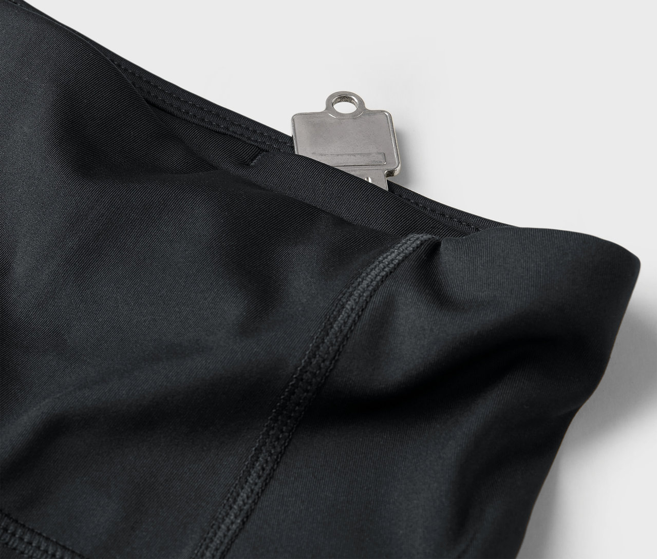 Fekete leggings közelképe kulccsal a zsebben.