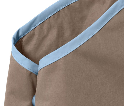 Egy barna kisgyerek esőnadrág részlete kék szegéllyel.