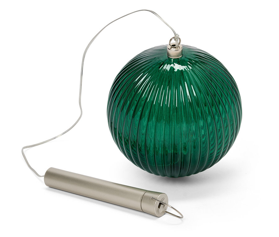 Egy zöld üveggömb texturált felülettel, amely egy ezüst színű hengeres csőhöz van rögzítve egy dróttal.