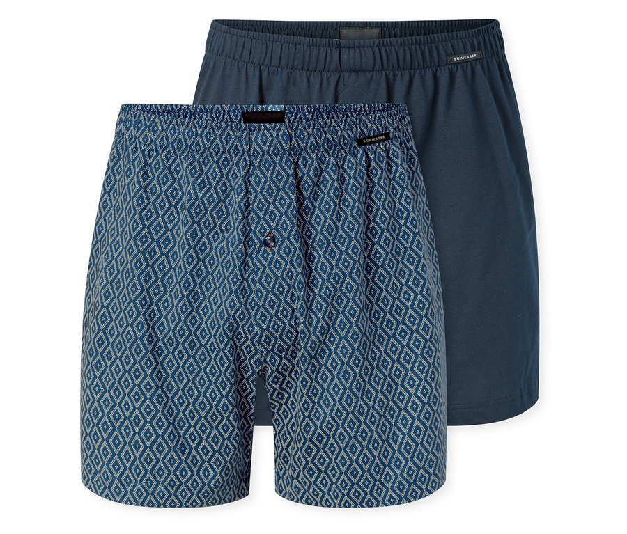 Két SCHIESSER jersey boxeralsó; az egyik kék, fehér rombuszmintás és gombos sliccel, a másik egyszínű sötétkék.
