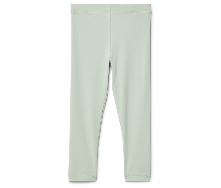 Egy világoszöld leggings fekszik egy fehér háttéren.