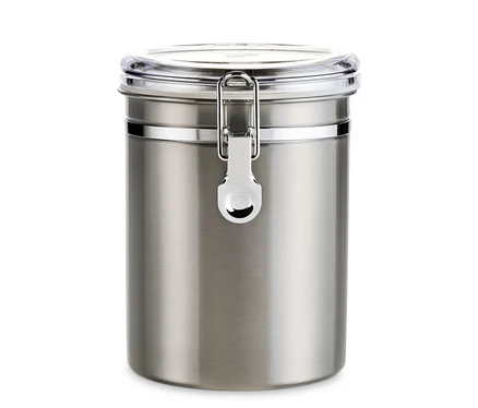 Egy rozsdamentes acél aromatartó doboz átlátszó fedővel és zárral.