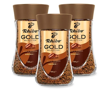 Három üveg Tchibo Gold Selection instant kávé egymás mellett.