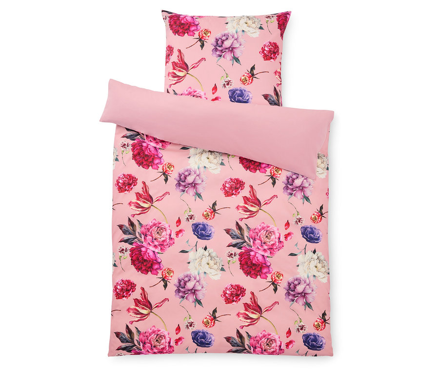 Rózsaszín virágmintás ágyneműgarnitúra párnával és huzattal.