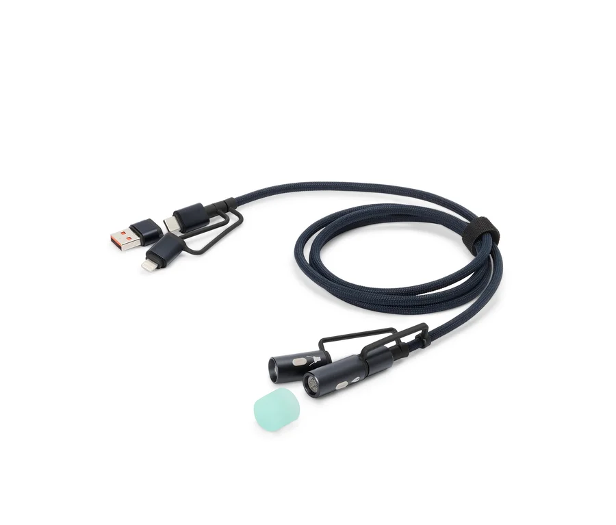 Egy kék töltőkábel USB, USB-C és Lightning csatlakozókkal, valamint két kis LED lámpával és egy szilikon rátéttel fekszik egy fehér háttéren.