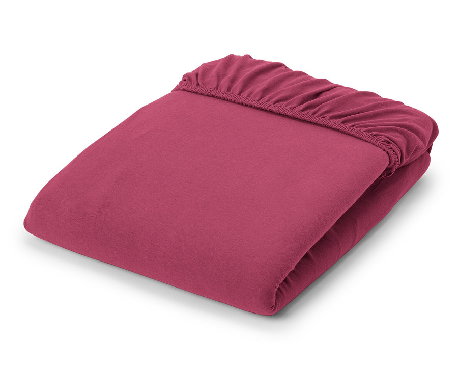 Összehajtott, bor színű jersey lepedő.