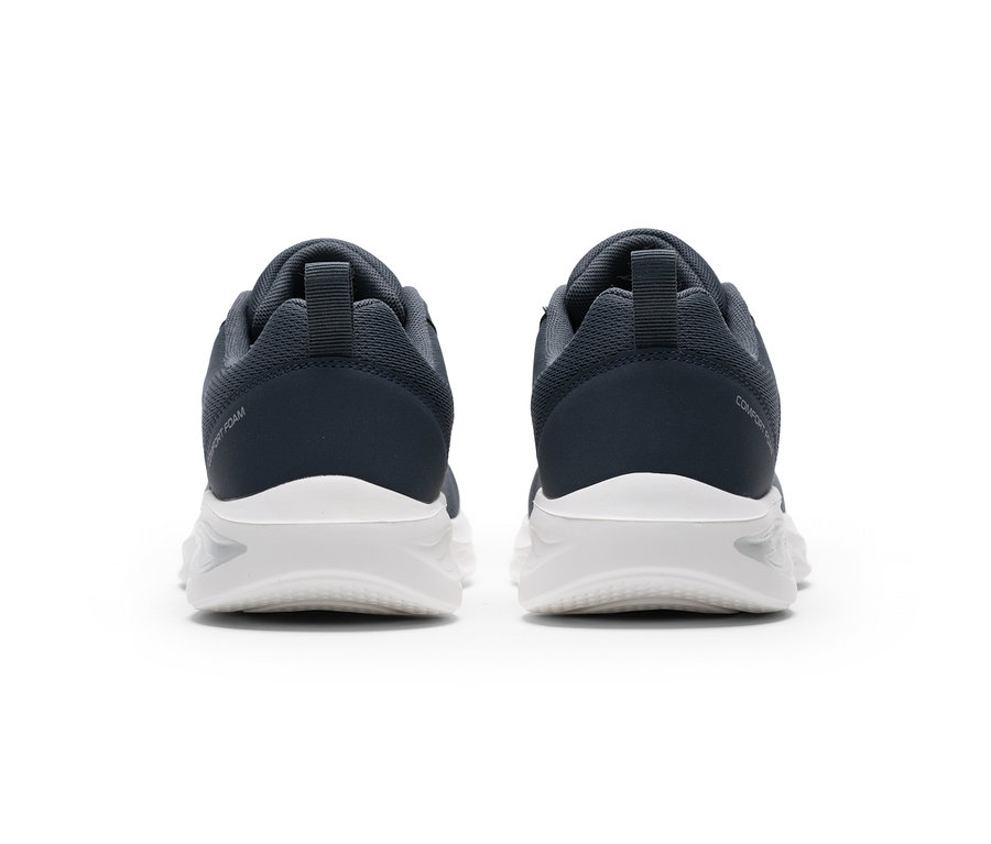 Két sötétszürke sportcipő fehér talppal, hátulról nézve. A bal cipőn „COMFORT FOAM”, a jobbon „COMFORT” felirat látható.