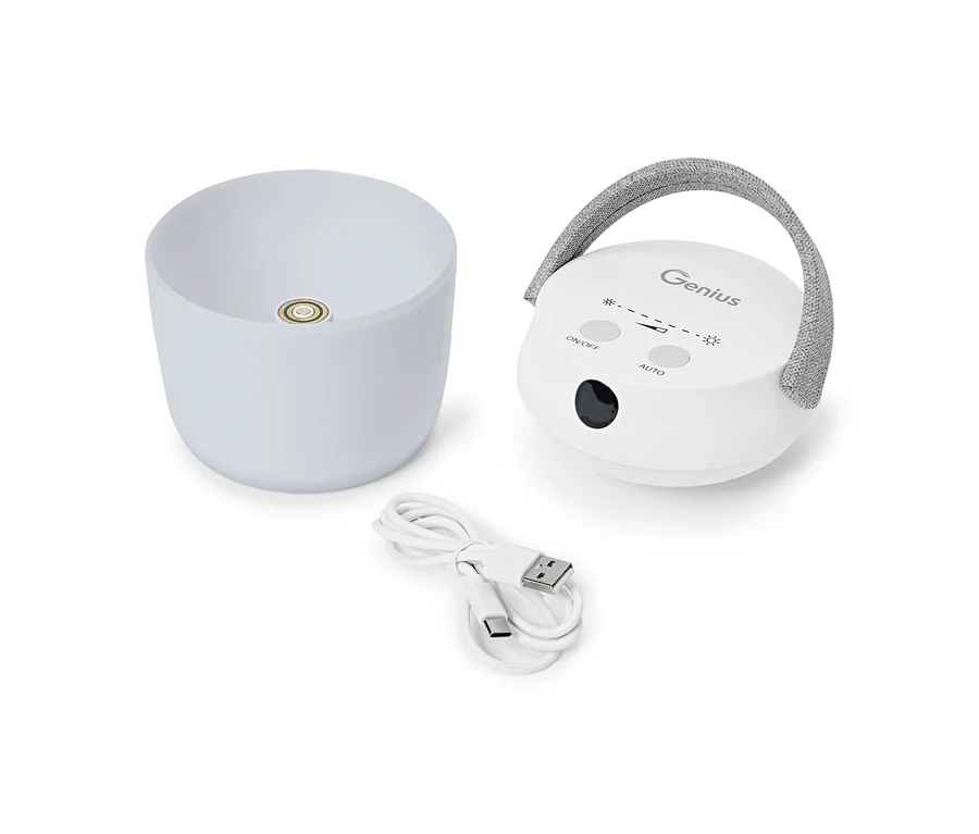 Fehér, hordozható, kerek eszköz szürke szövet fogantyúval, mellette egy fehér tál alakú diffúzor és egy tekercselt USB-C kábel.