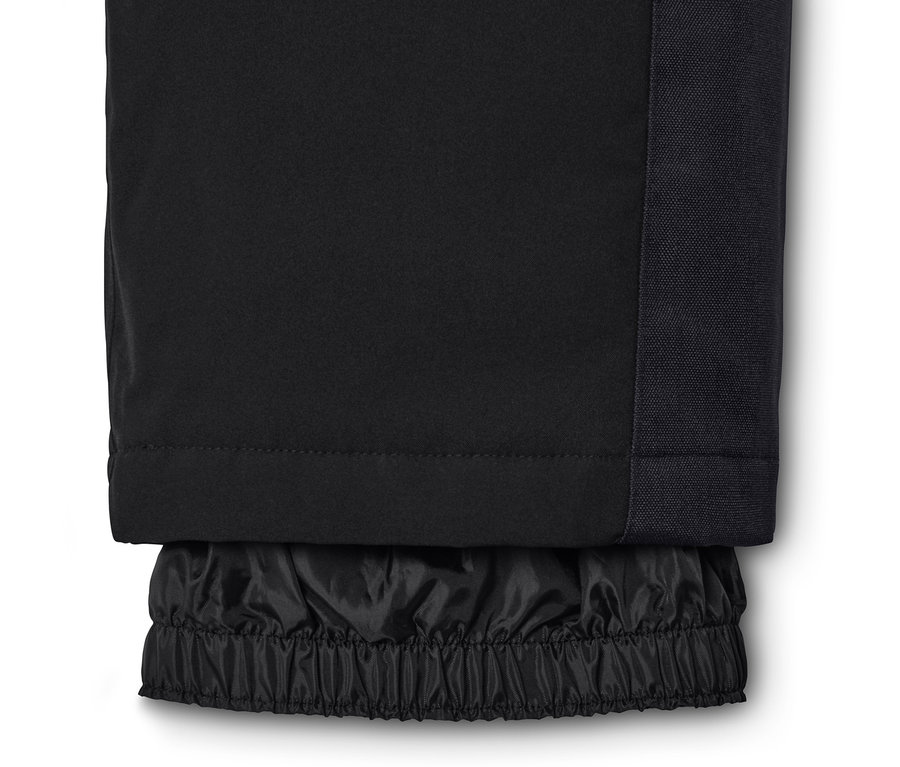 Egy fekete, magas derekú sínadrág részlete.