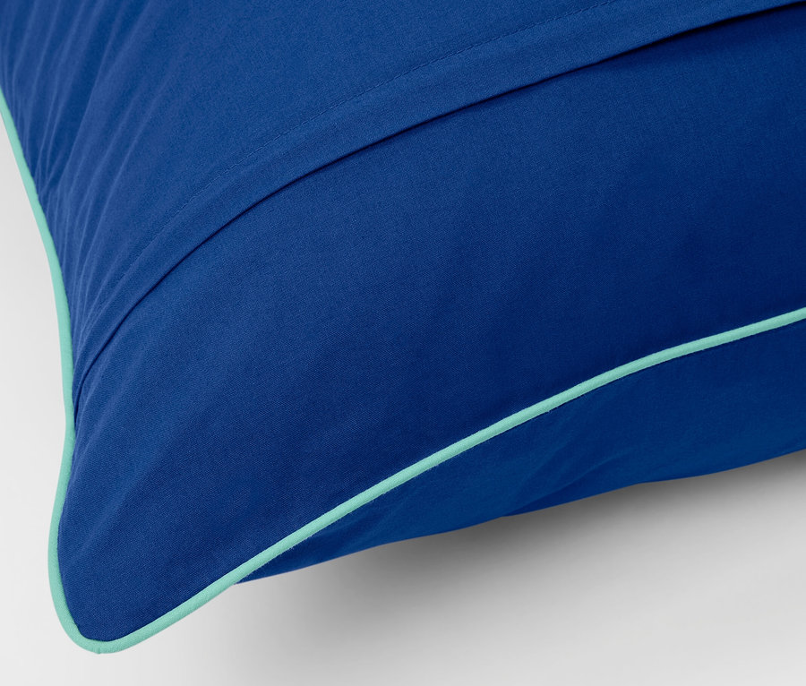 Kék, normál méretű renforcé ágynemű részlete türkiz szegéllyel.