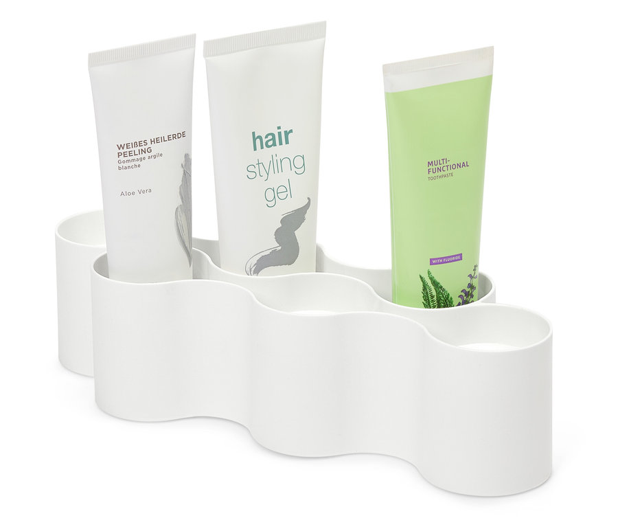 Három tubus kozmetikum fehér műanyag tartóban.