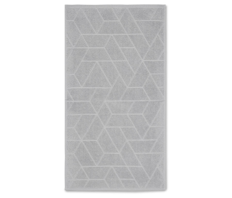 Szürke törölköző geometriai mintával.