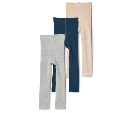 Három gyermek leggings szürke, sötétkék és bézs színben egymásra helyezve, fehér háttér előtt.