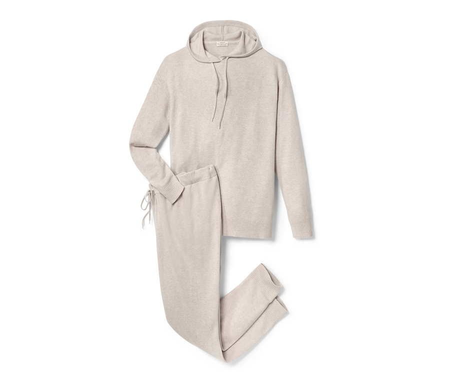 Egy bézs színű kismama szabadidő szett kapucnis pulóverrel és nadrággal fehér háttéren.