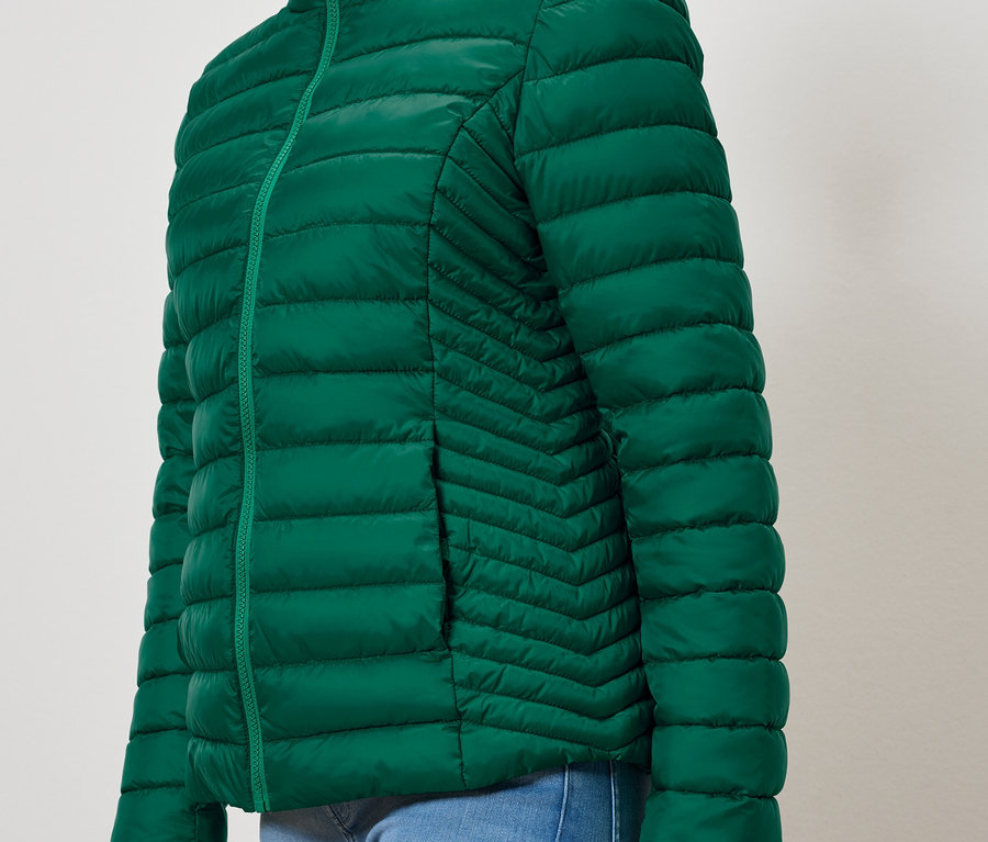 Zöld steppelt kabát zsebbel.