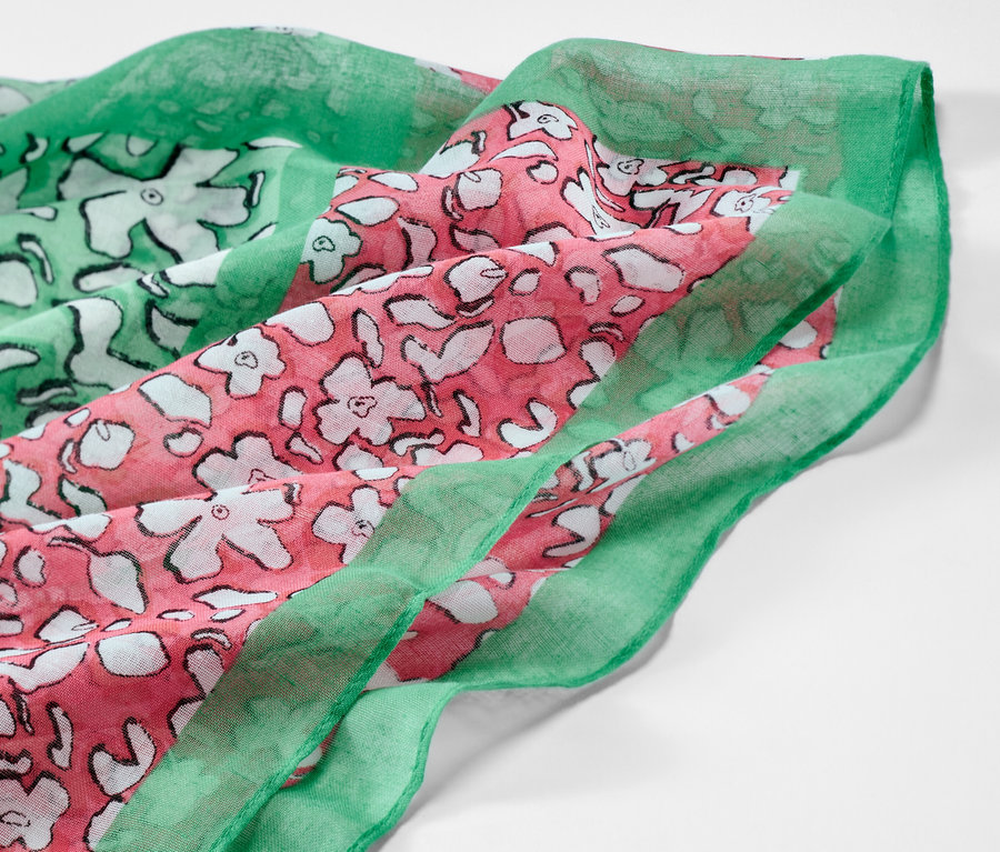 Egy nyomott mintás körsál részlete, zöld és rózsaszín virágmintával.