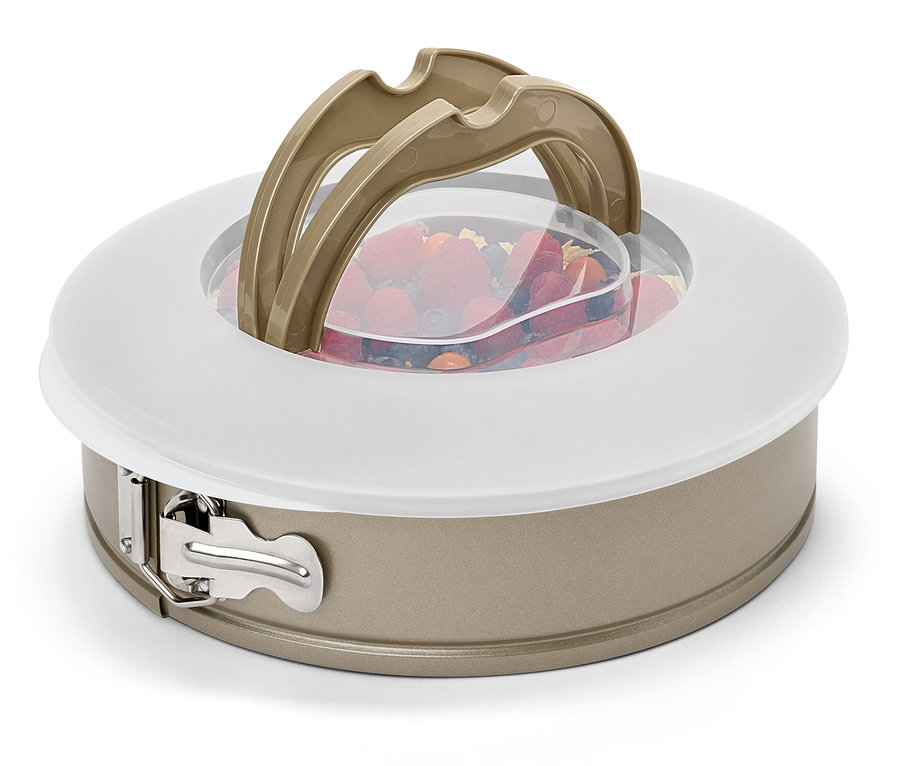 Gyümölcsöt tartalmazó tortaforma fedővel és fogantyúkkal.