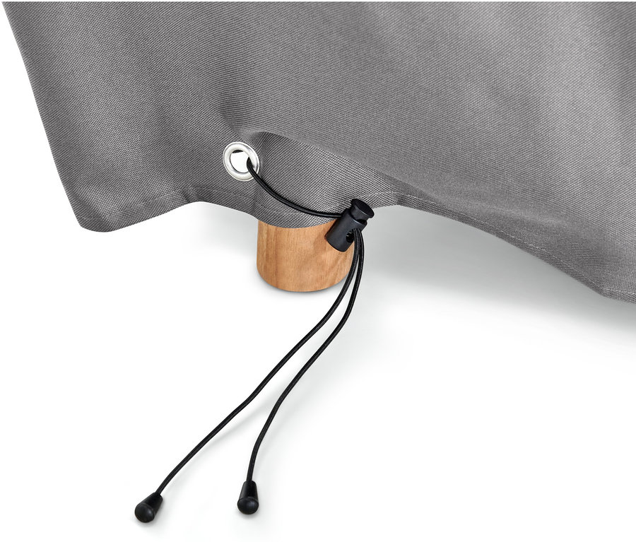 Egy szürke, prémium minőségű, nagyméretű, kihúzható asztalokhoz való huzat részlete fekete zsinórral és egy fa asztallábbal.