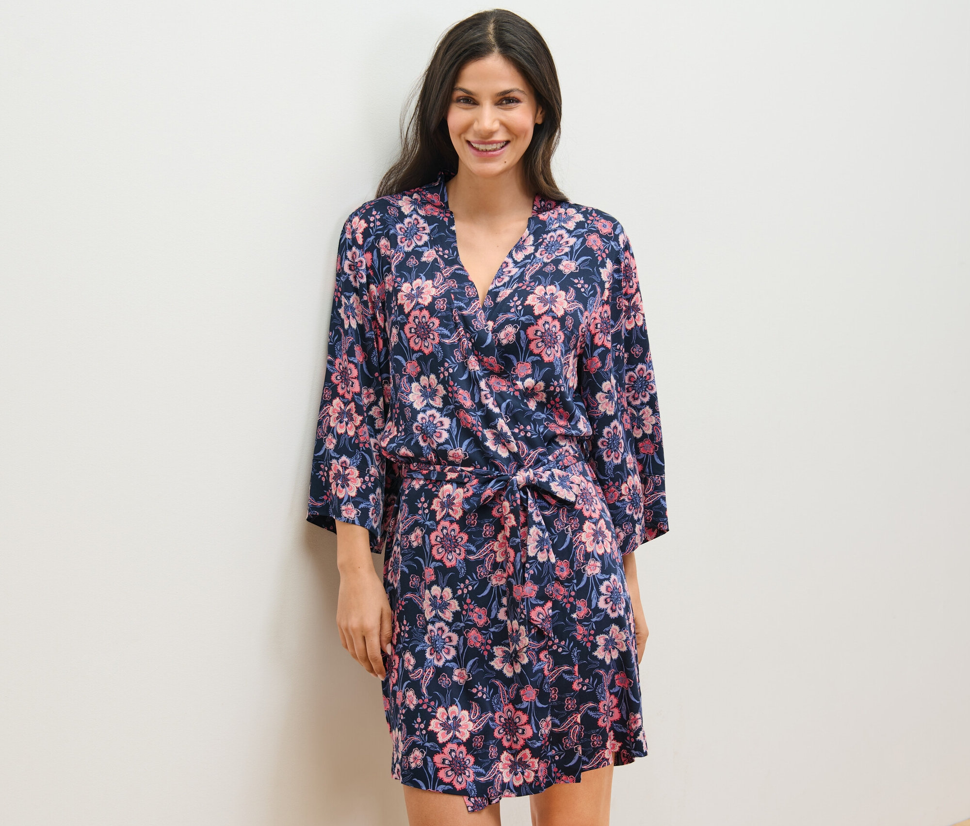 Nő virágmintás, sötétkék női kimonót visel.