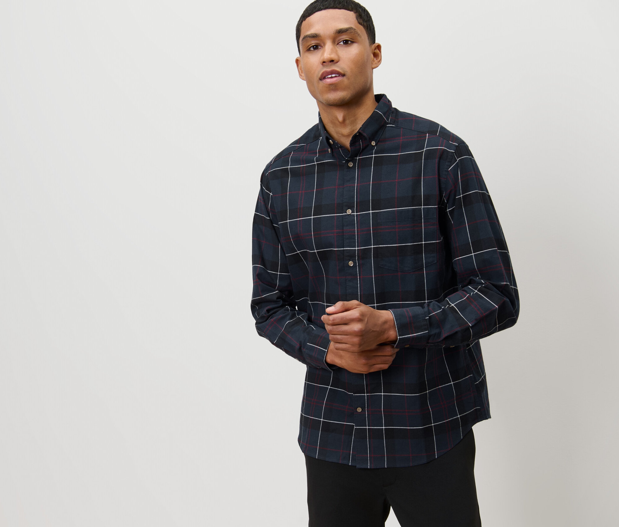 Férfi pózol sötétkék kockás flanelingben.