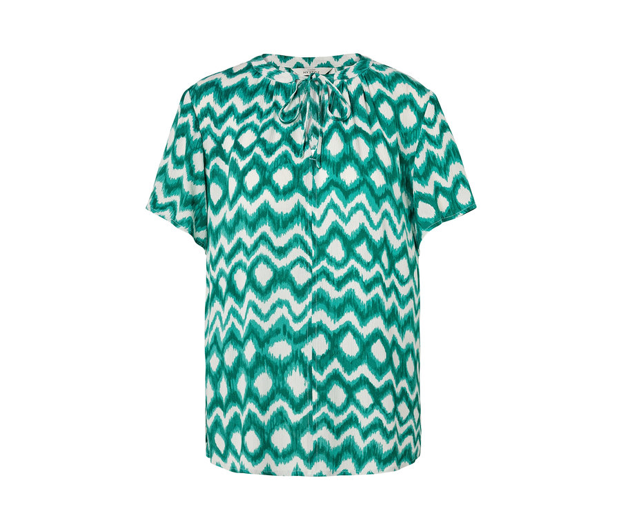 Fehér tunikablúz zöld mintával.