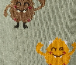 Kötött leggings részlete, rajzolt szörny motívumokkal.