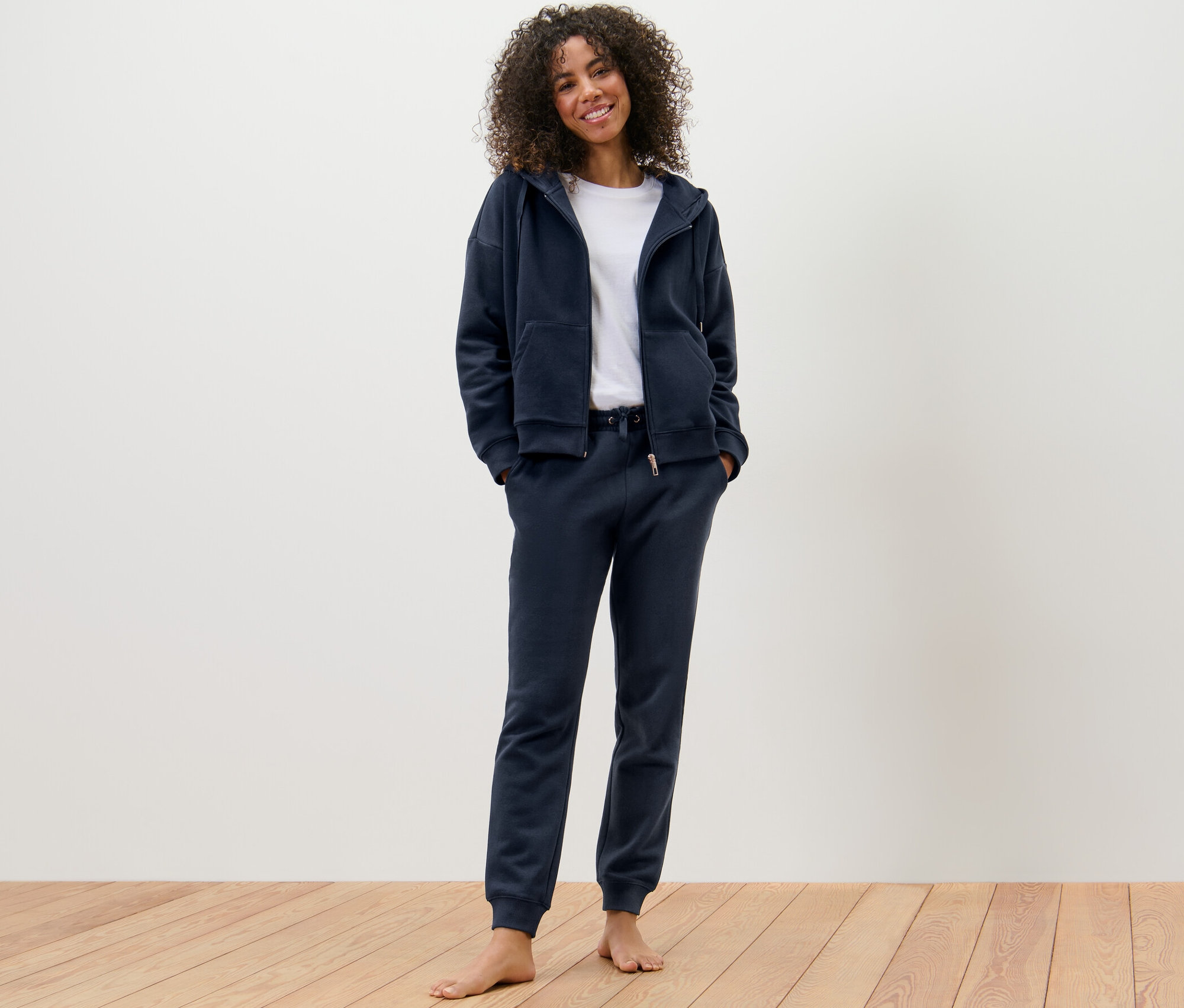 Nő visel sötétkék női szabadidő szettet.