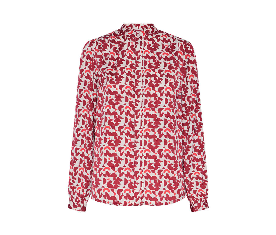 Egy piros geometrikus mintás női hosszú ujjú blúz részlete.
