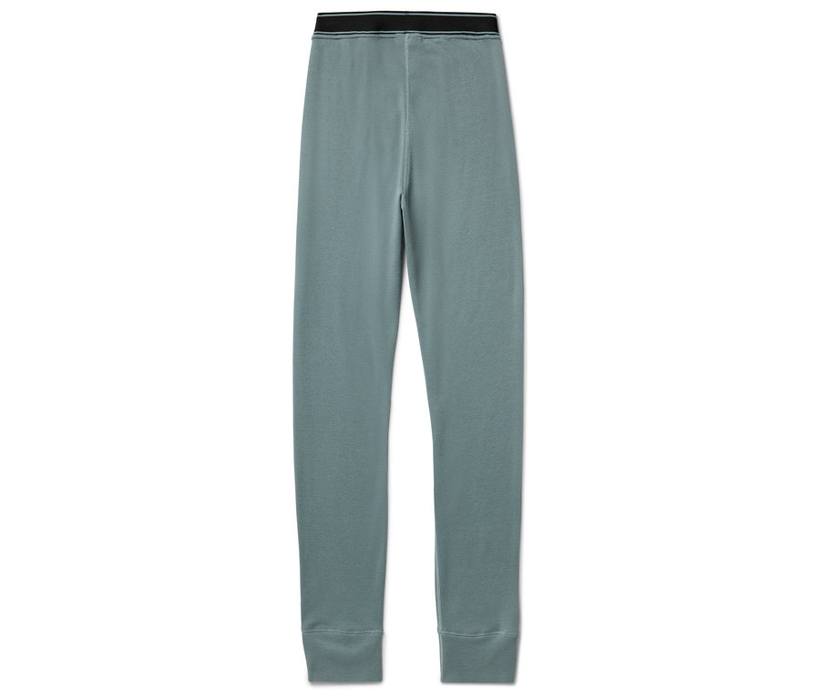 Kék leggings fekete derékpánttal, fehér háttérben.