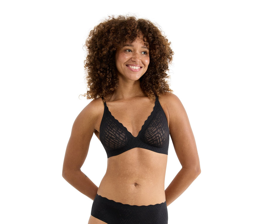 Göndör hajú nő fekete melltartóban és alsóneműben.