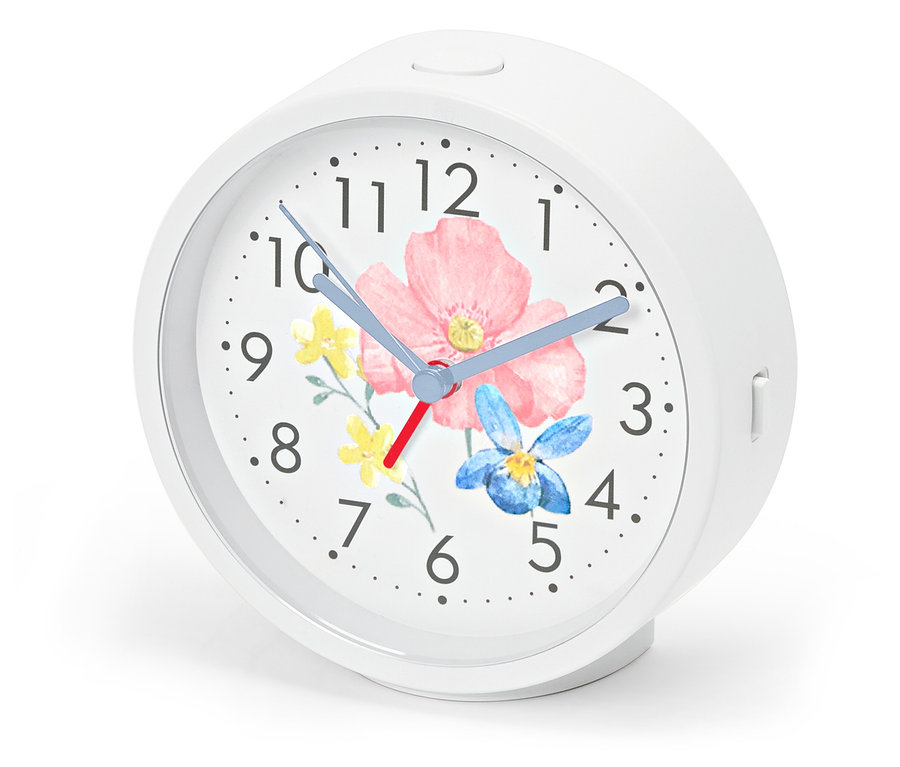 Ébresztőóra háttérvilágítással, virágmintás számlap.