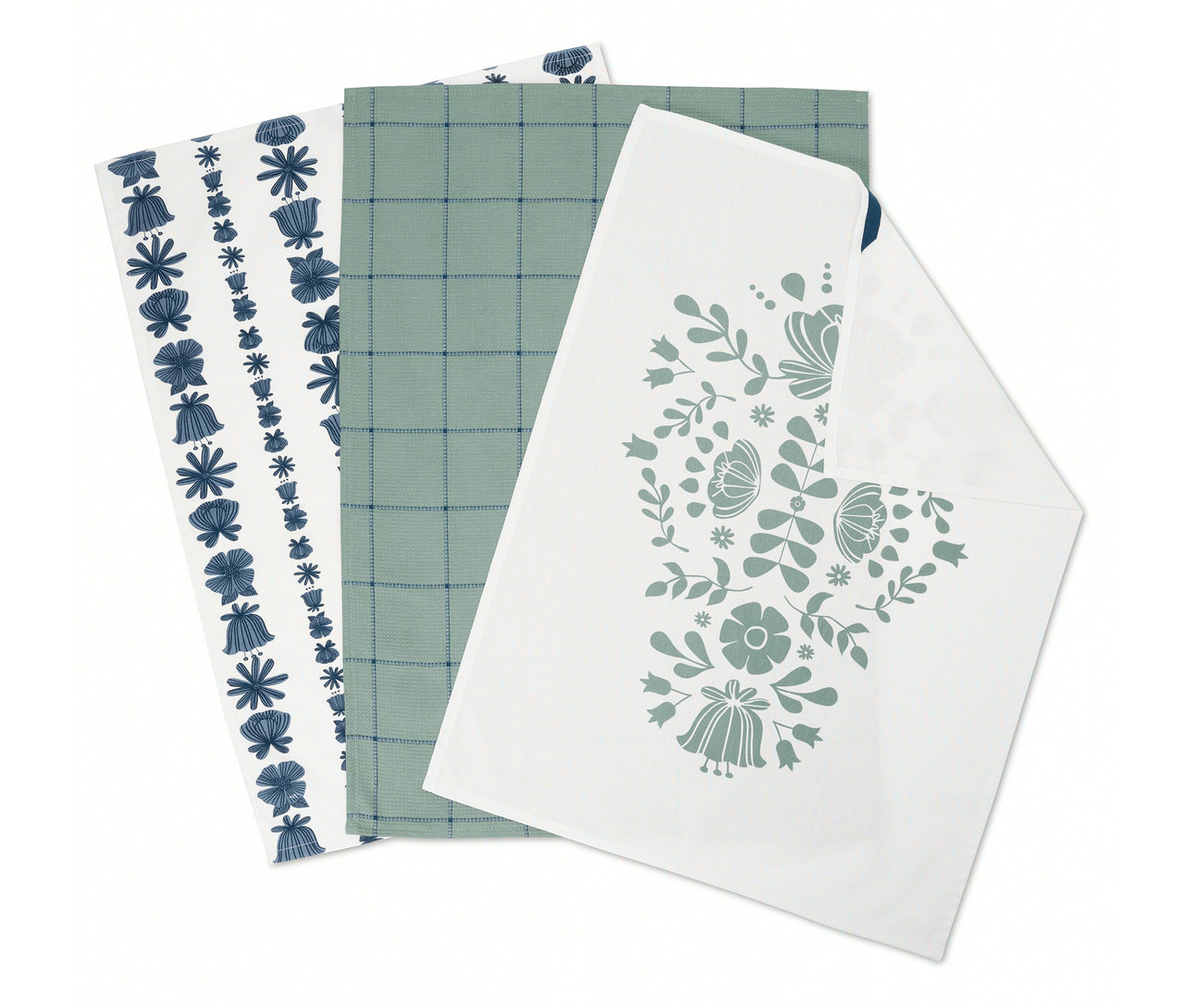 Három összehajtott konyharuha: egy kék virágokkal, egy zöld kockás mintával és egy virágmintával.