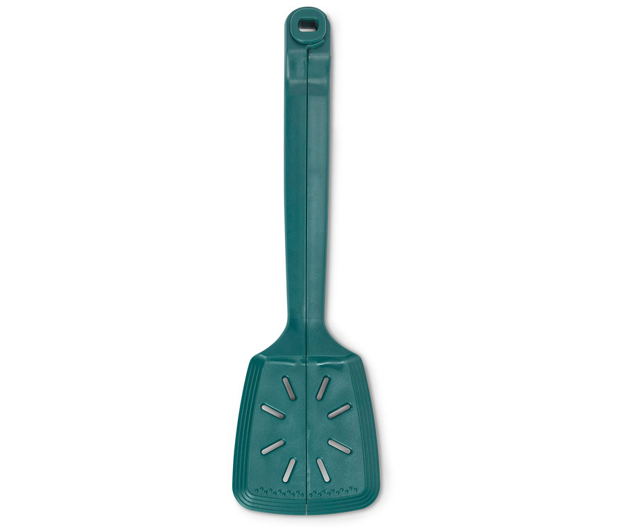Egy zöld konyhai spatula fekszik egy fehér háttéren.