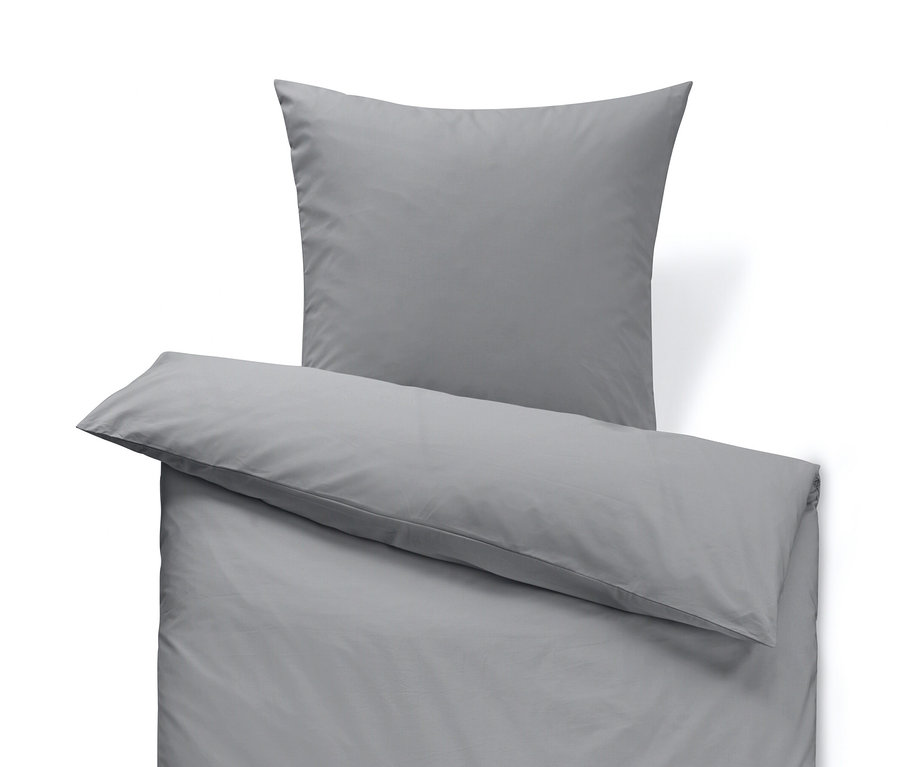 Szürke, normál méretű perkál ágynemű párnával a tetején.