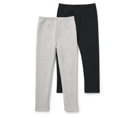Két leggings, egy szürke és egy fekete, egymás mellett fekszik fehér háttérrel.
