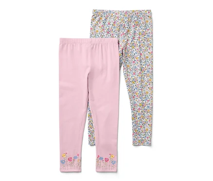 Két kislány leggings: egy rózsaszín virágokkal a szárak végén, egy fehér apró virágmintás.