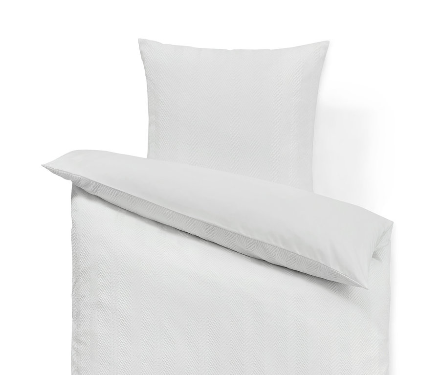 Fehér strukturált ágynemű, egyszemélyes, párnahuzattal.