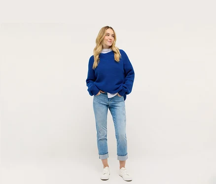Nő kék kötött kabátot és Angels denim »Cira Boho« farmert visel.