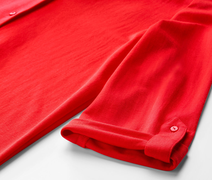 Egy piros piké jersey blúz részlete.